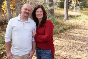 Craig & Coletta Smith, photographed on wooded path in the fall