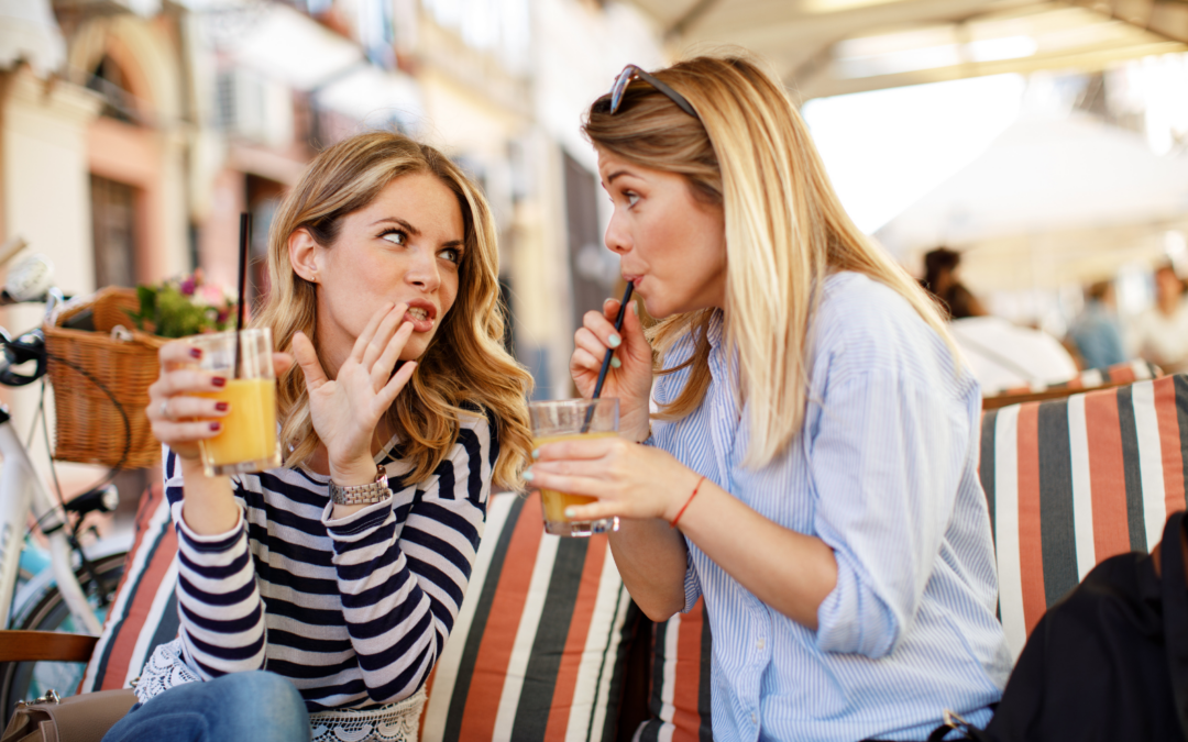 Two women at breakfast gossiping.